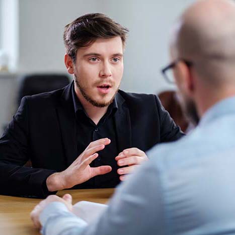 Confident young man attending job interview