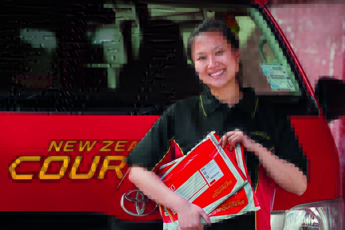NZC Lady in front of van with packs